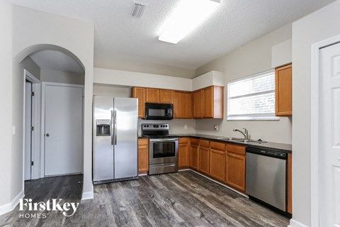 a kitchen with stainless steel appliances and wooden cabinets