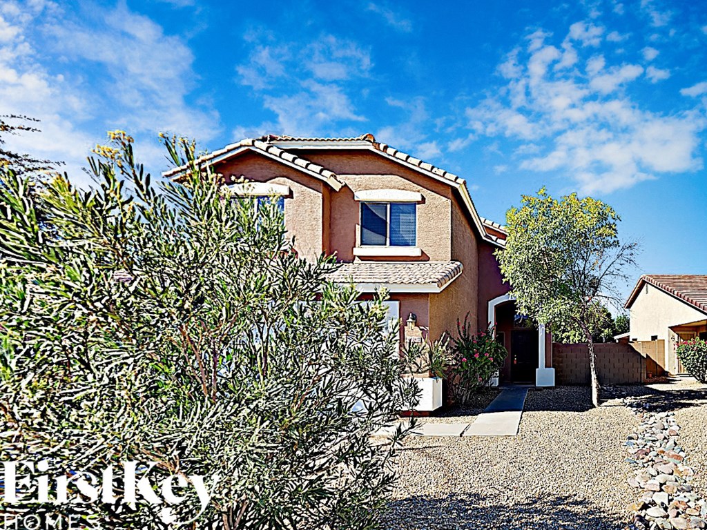 a house with an olive tree in front of it