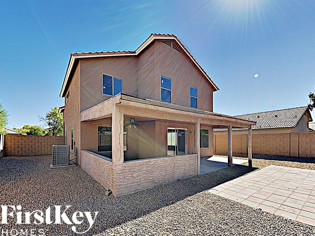 a brick house with a covered porch and a patio