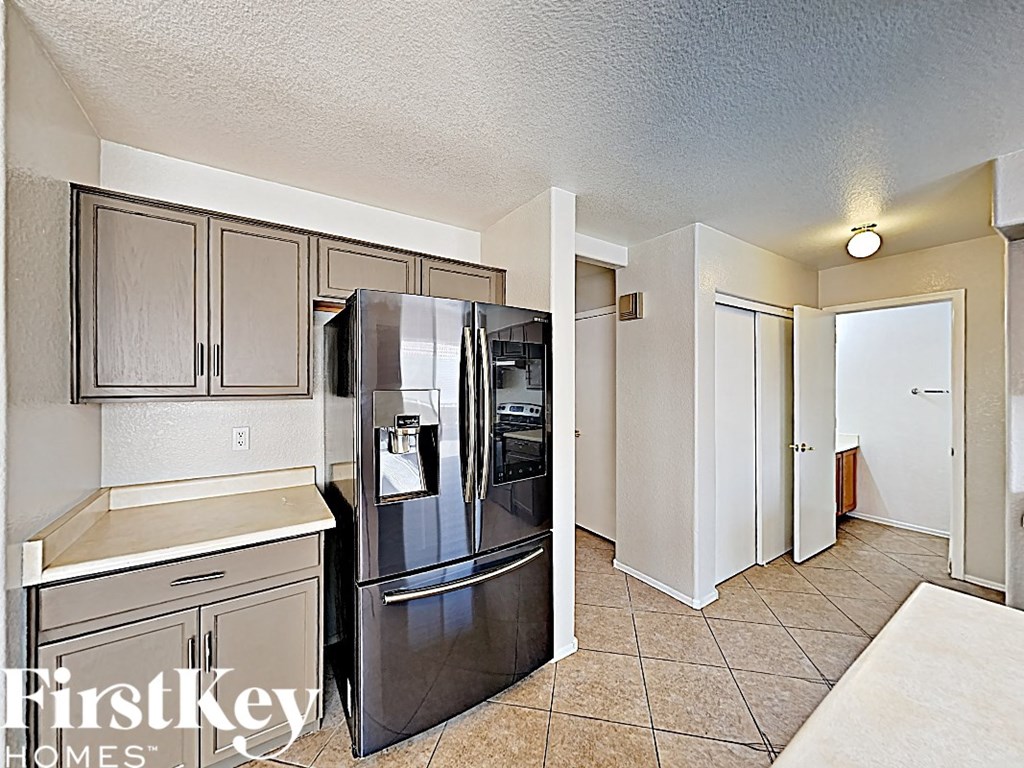 a kitchen with stainless steel appliances and white cabinets