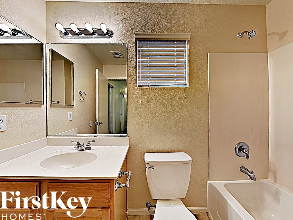 a bathroom with a toilet and a sink and a mirror