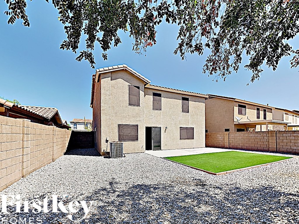 a large brick house with a yard in front of it