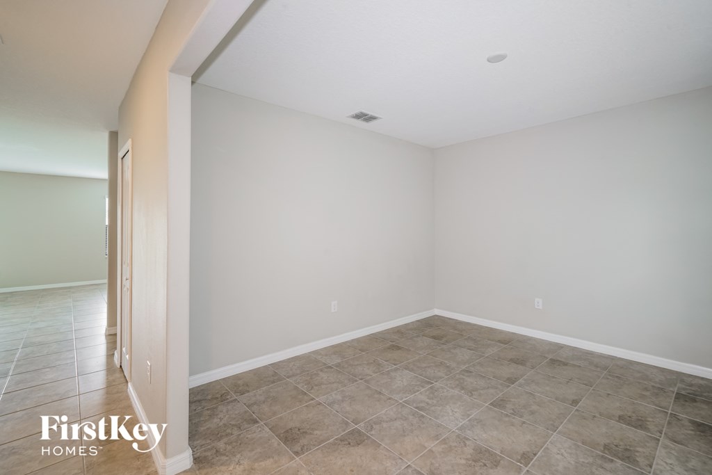 A room with a tile floor and a white wall.
