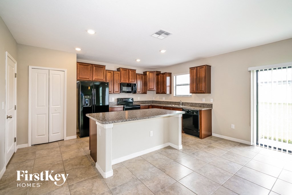 A kitchen with a white island in the middle of the room.