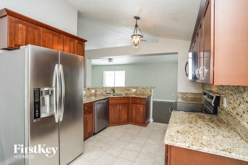 a kitchen with stainless steel appliances and granite counter tops