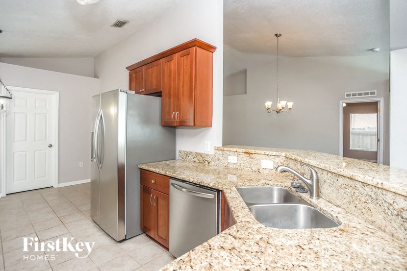 a kitchen with granite counter tops and stainless steel appliances