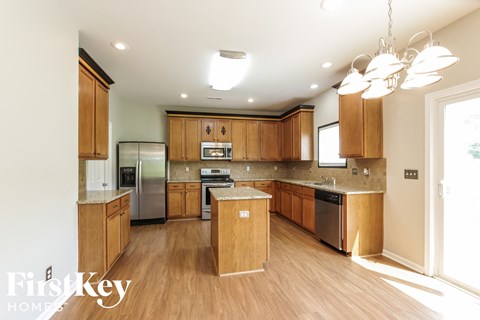 a kitchen with wooden cabinets and stainless steel appliances