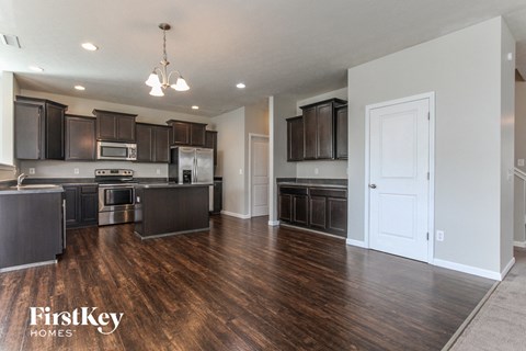 A kitchen with dark wood cabinets and a white door.