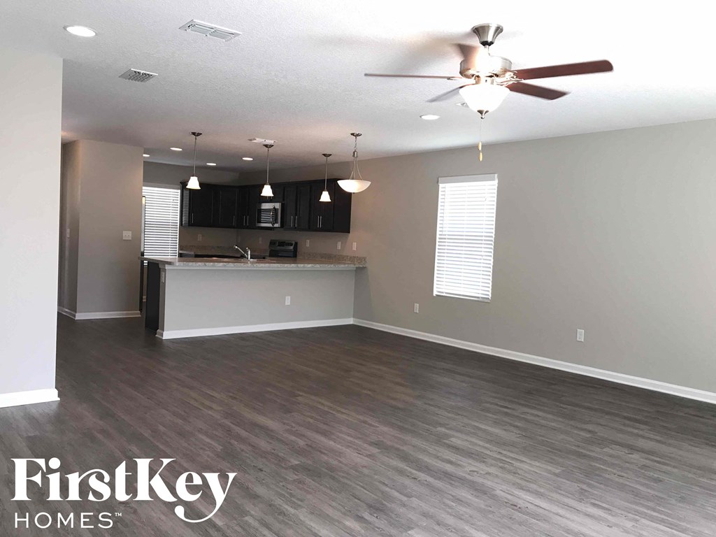 A spacious kitchen and living room with a FirstKey Homes logo.