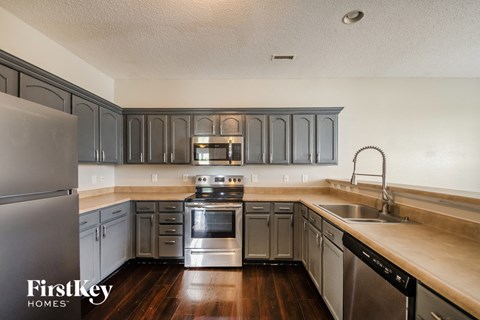 A kitchen with a stove, oven, and refrigerator.