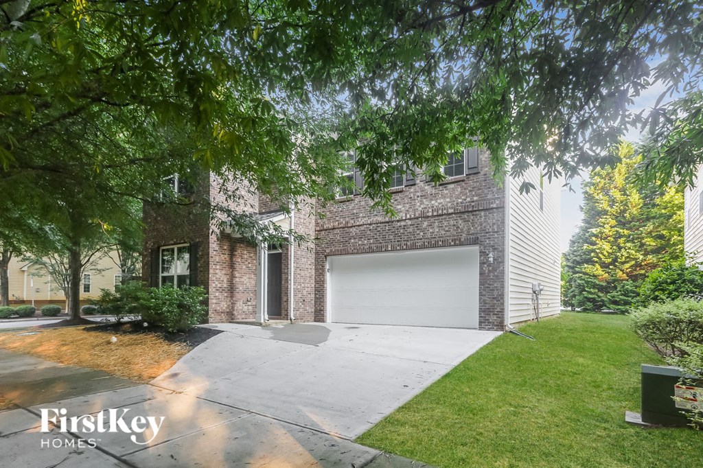 a garage door on a brick house with a driveway