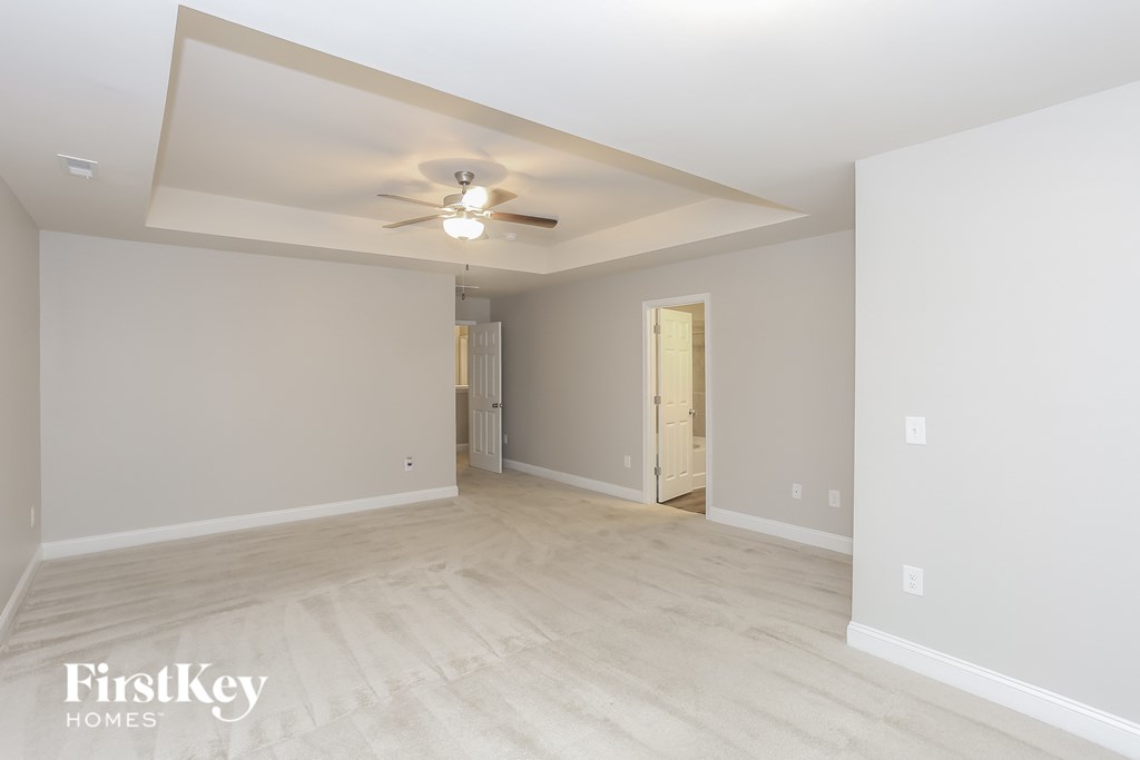 the living room and dining room are spacious and lighted by a ceiling fan
