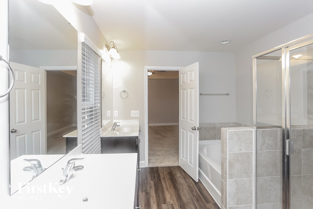 a bathroom with a shower and a sink and a mirror