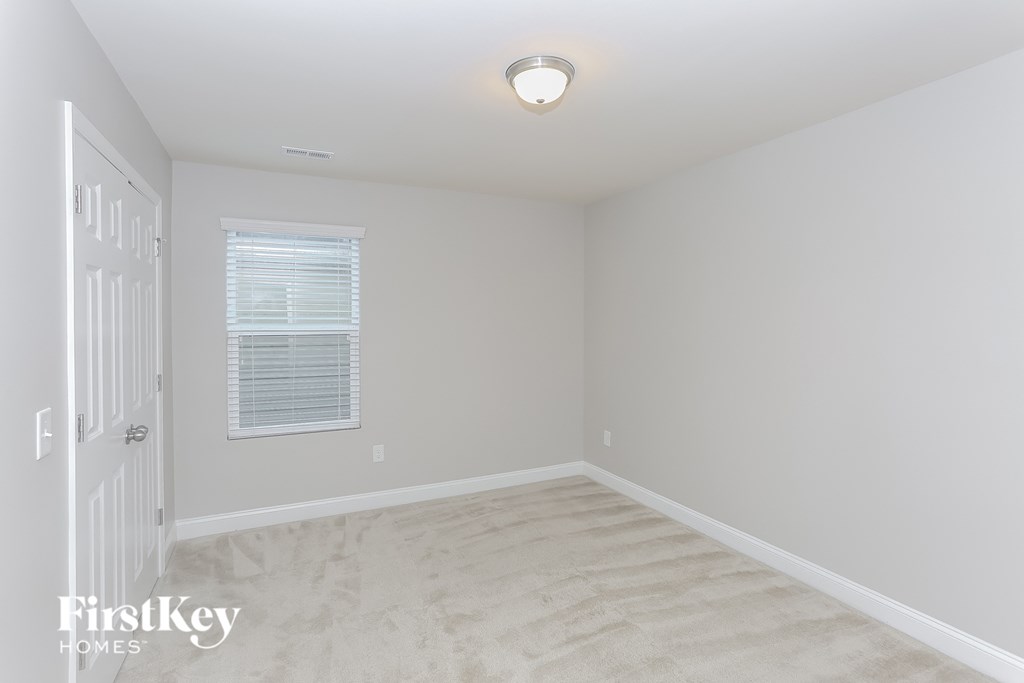 a white room with a white carpet and a white door