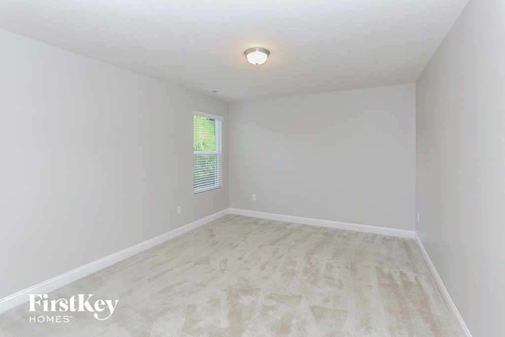 an empty room with white walls and a window