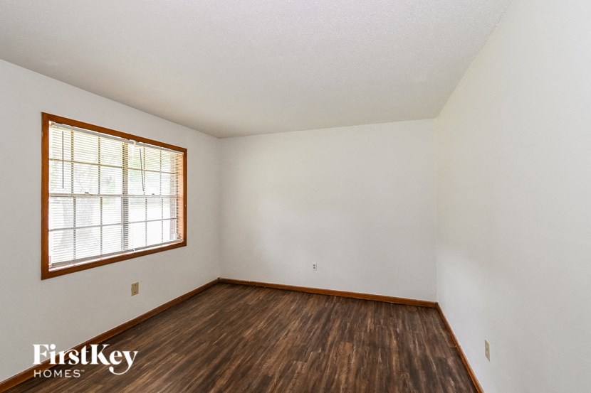 A room with wooden floors and a window.