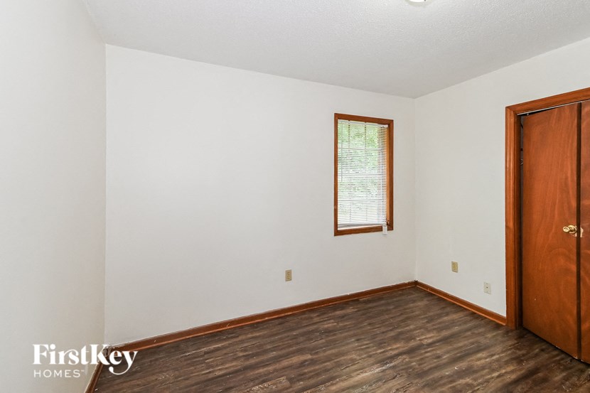 A room with a wooden floor and a door.