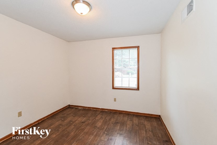 A room with a wooden floor and a window.