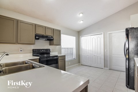 a kitchen with stainless steel appliances and white counter tops
