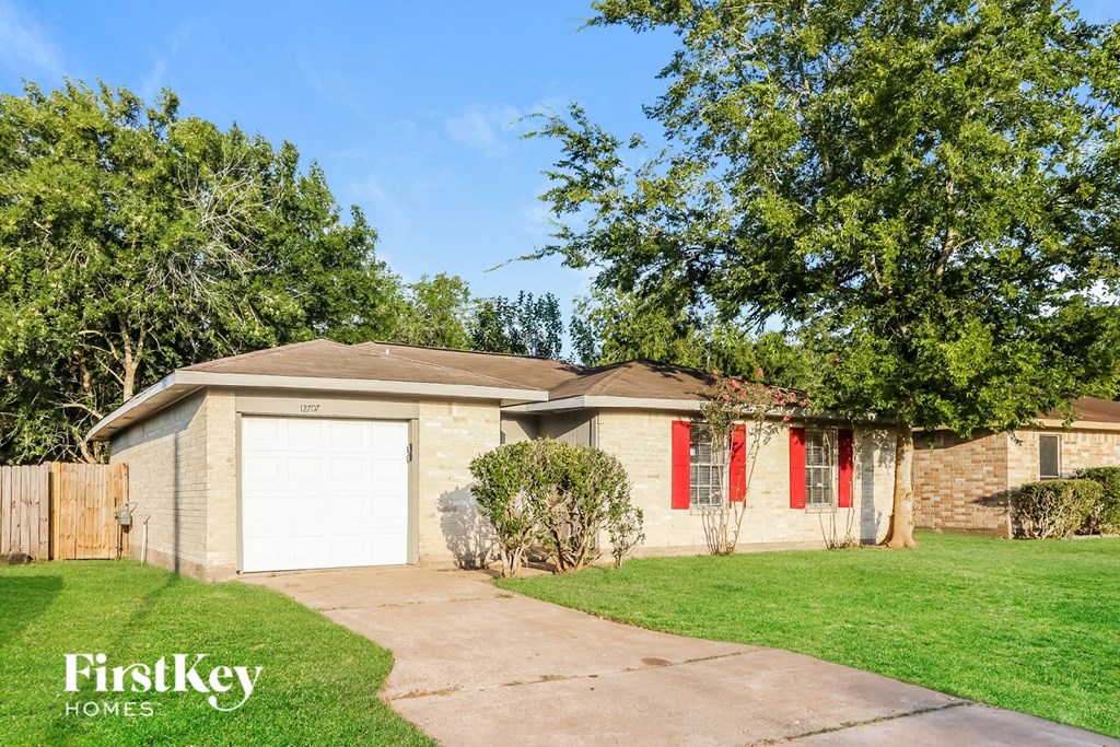 A house with a garage and a driveway is for sale.