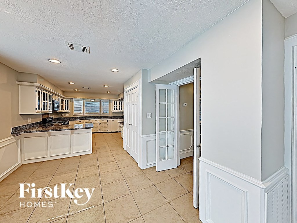 the kitchen is open to the dining room and living room