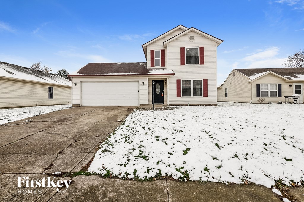 a white house with snow on the ground