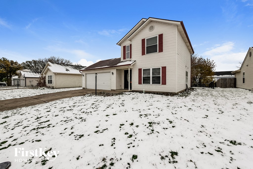 a house in the snow with the yard covered in snow
