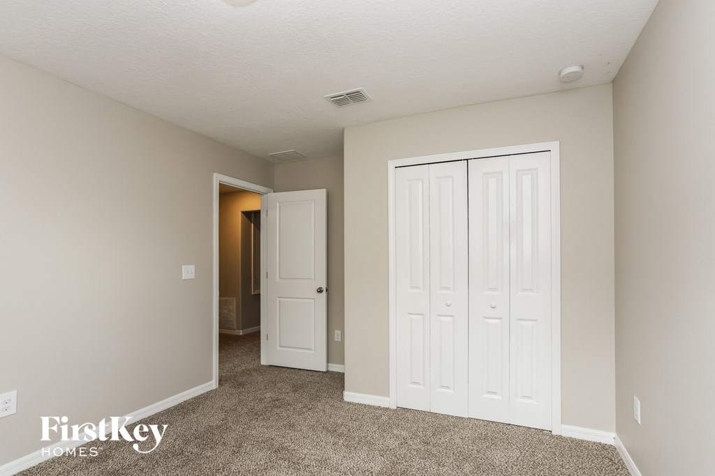 a bedroom with two closets and a door to a bathroom