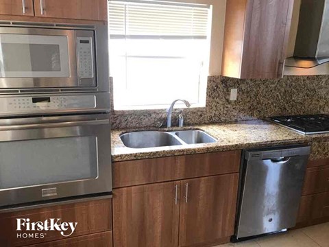 A kitchen with a FirstKey Homes logo.