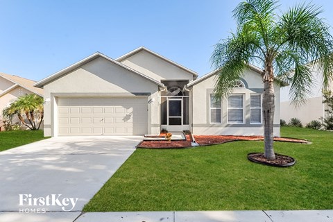 a home with a palm tree in front of it