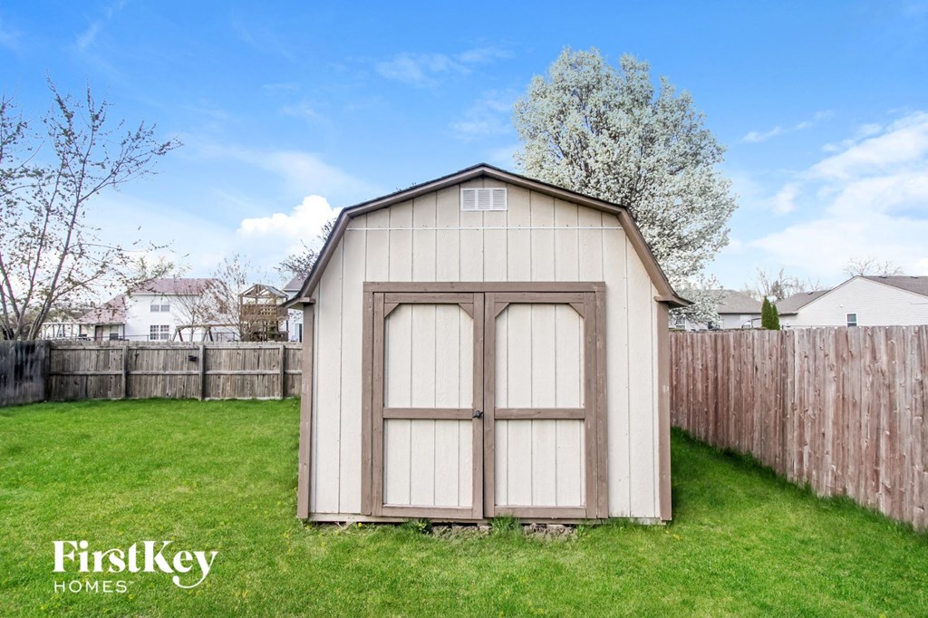 the outside of a small storage shed in a backyard
