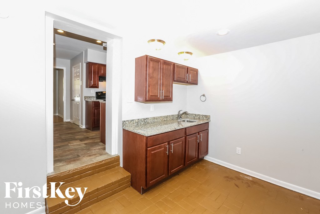 a kitchen with wooden cabinets and a counter top and a sink