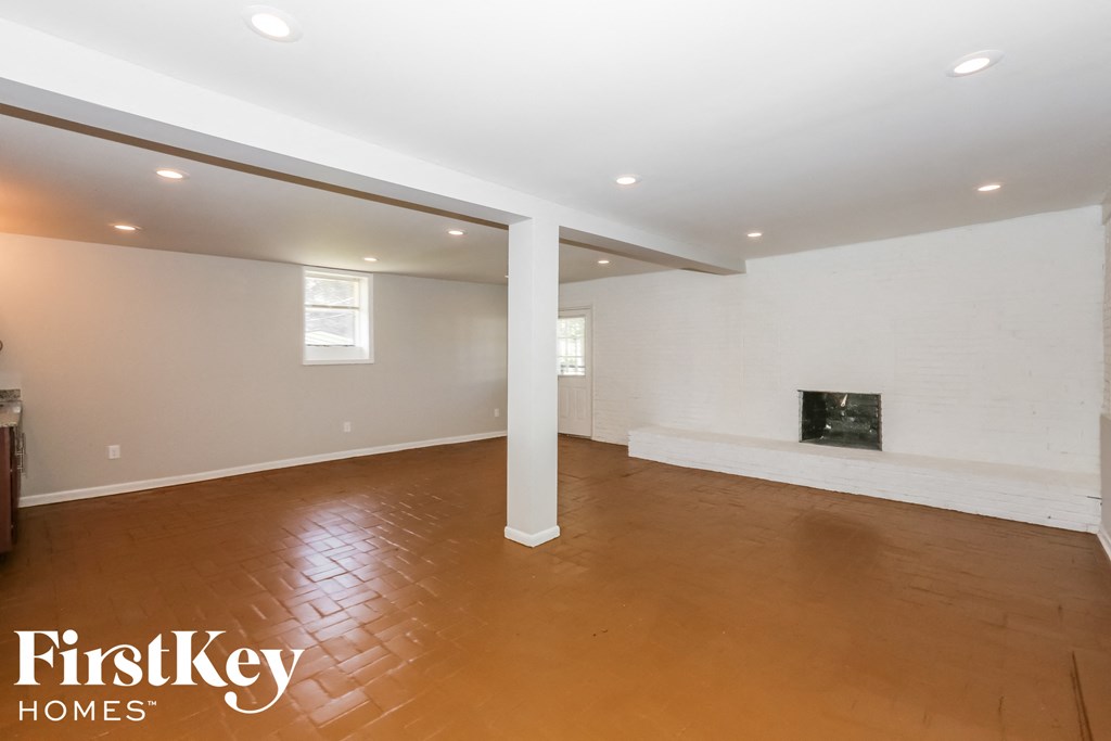 the living room with wood flooring and a fireplace