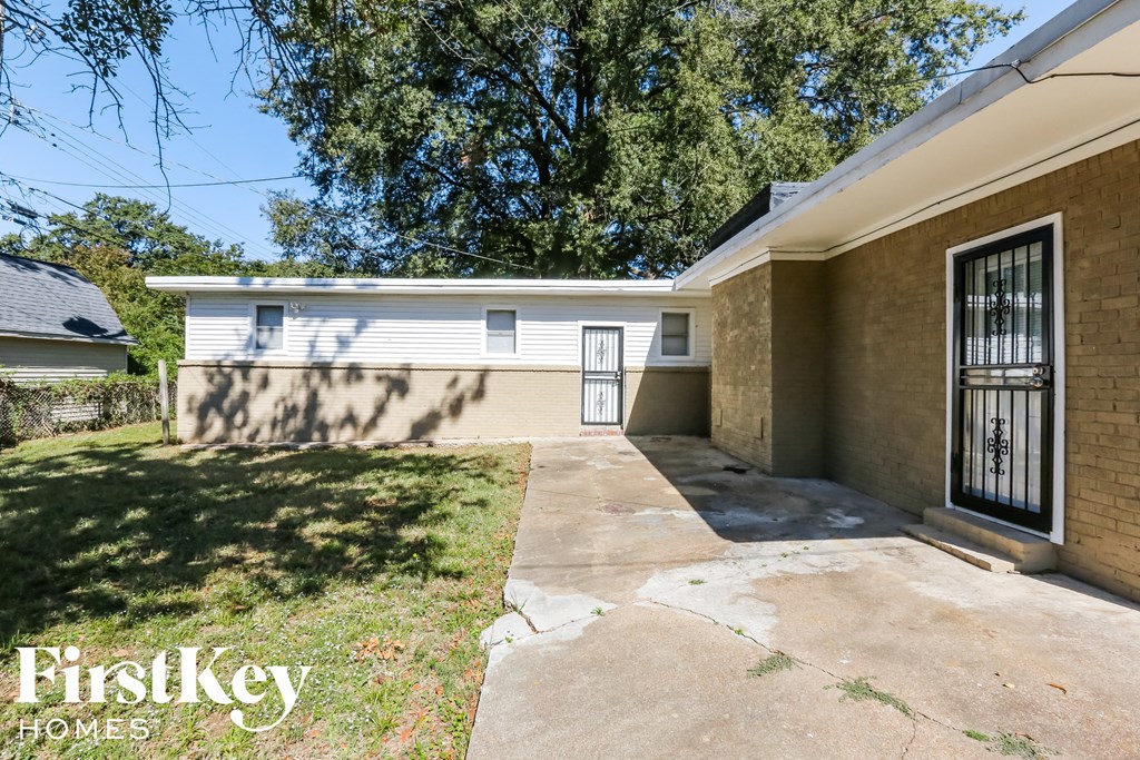 a small house with a driveway and a garage door