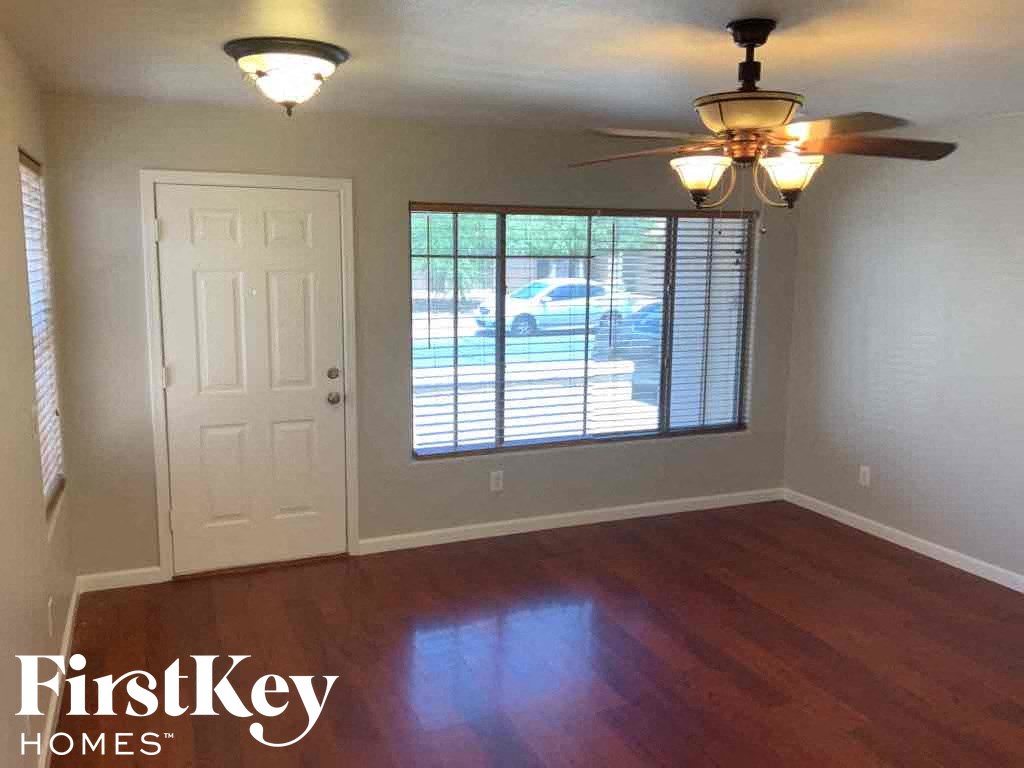 A room with a wooden floor and a ceiling fan.