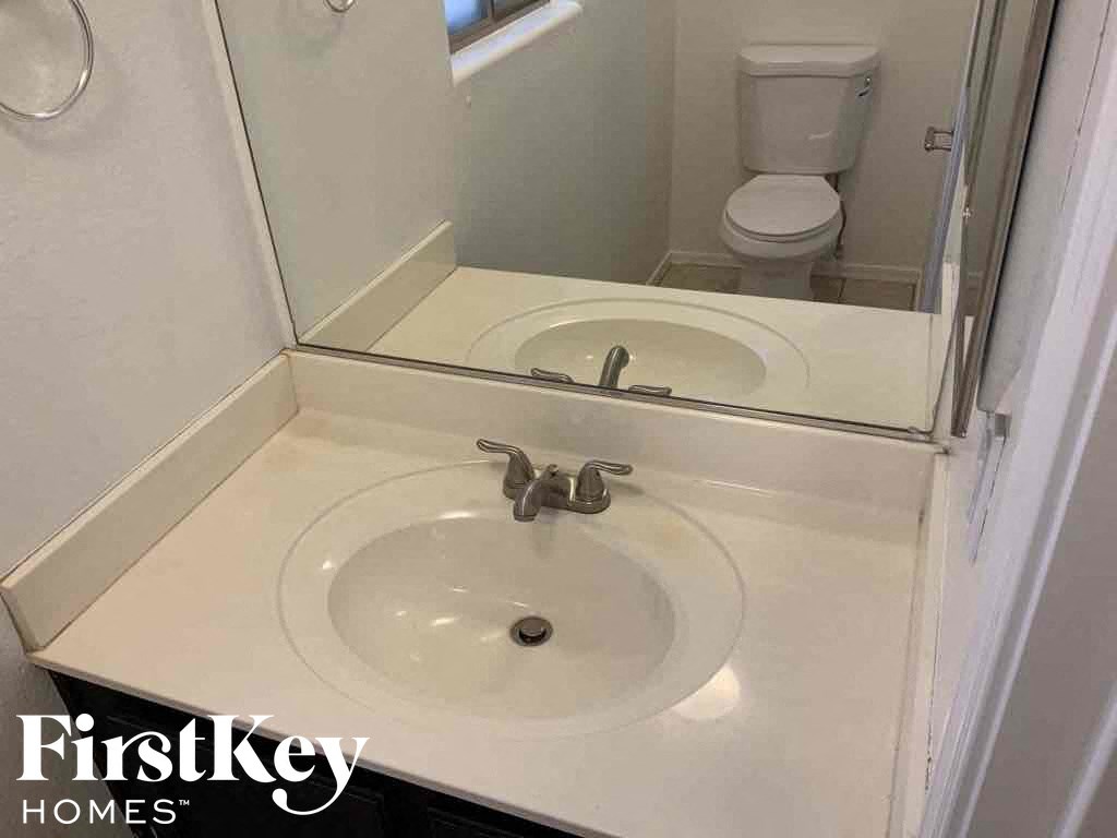 A white bathroom sink with a silver faucet.