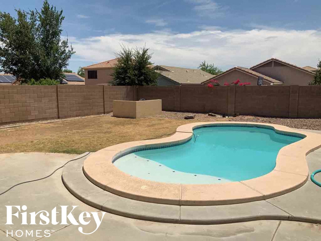 A small kidney-shaped pool with a concrete border.