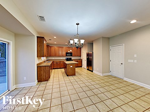 a large kitchen with a counter top and a sink