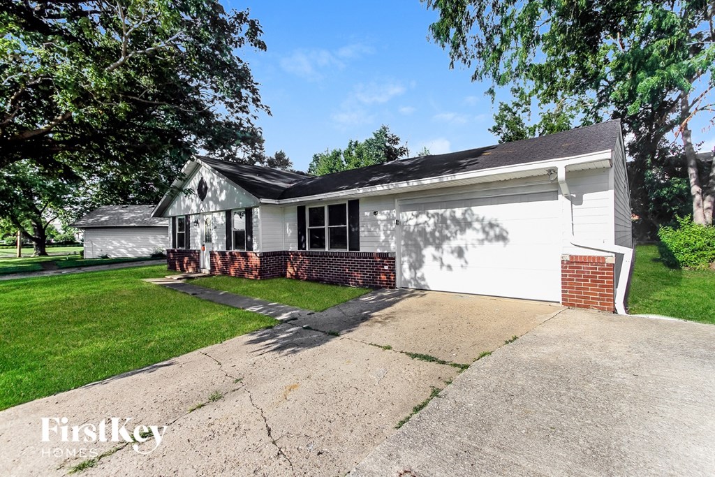 A house with a white garage door and a brick chimney.