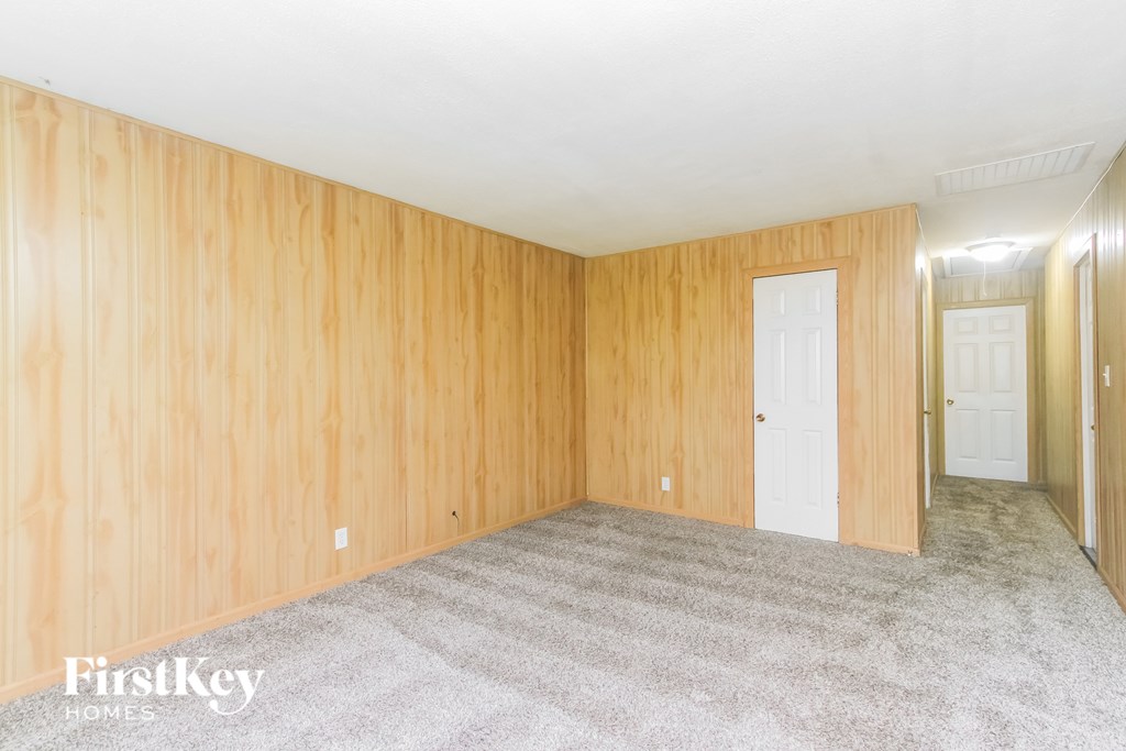 A room with wooden walls and carpeted floor.
