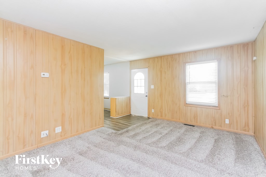 A room with wooden walls and a carpeted floor.