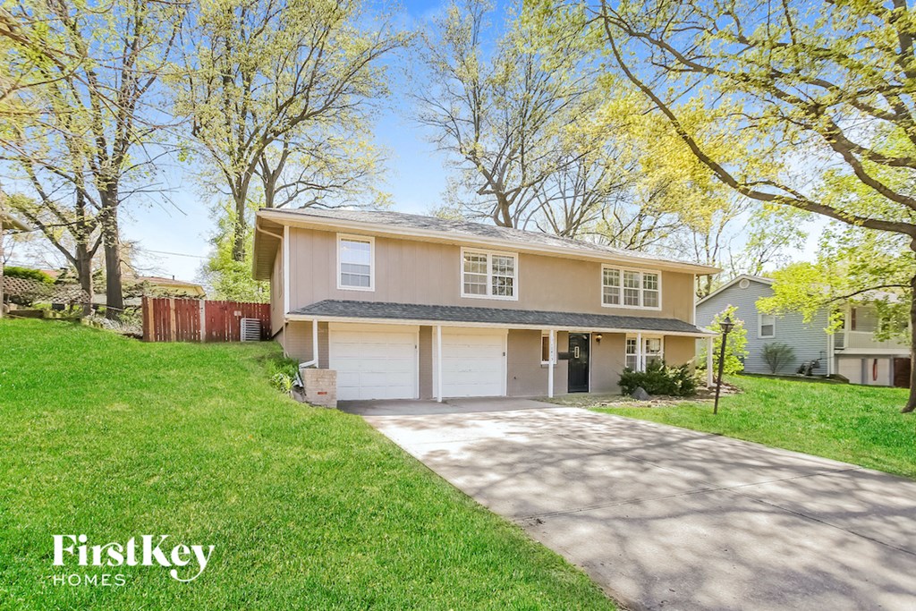 a house with a driveway and a garage door