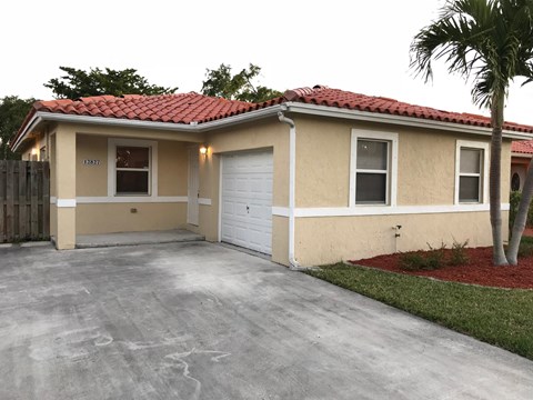 a home with a driveway and a garage door