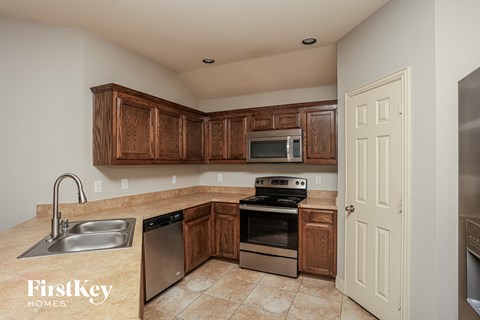 A kitchen with wooden cabinets and stainless steel appliances.