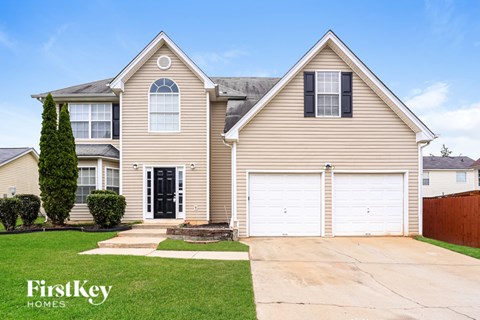 A two-story house with a garage is for sale by FirstKey Homes.