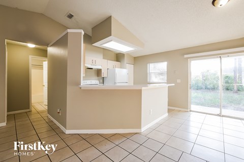 A kitchen area with a counter and cabinets.