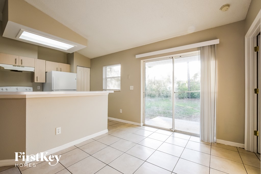 A kitchen with a refrigerator, cabinets, and a countertop.
