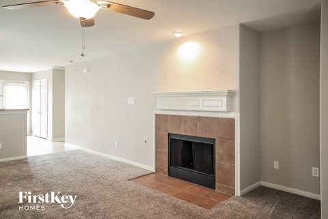 the living room of a new home with a fireplace