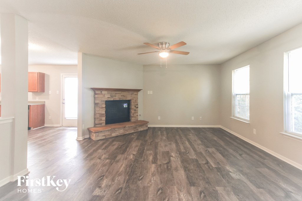 A spacious living room with a fireplace and a television.