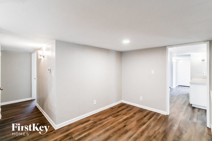 A room with wooden floors and white walls.